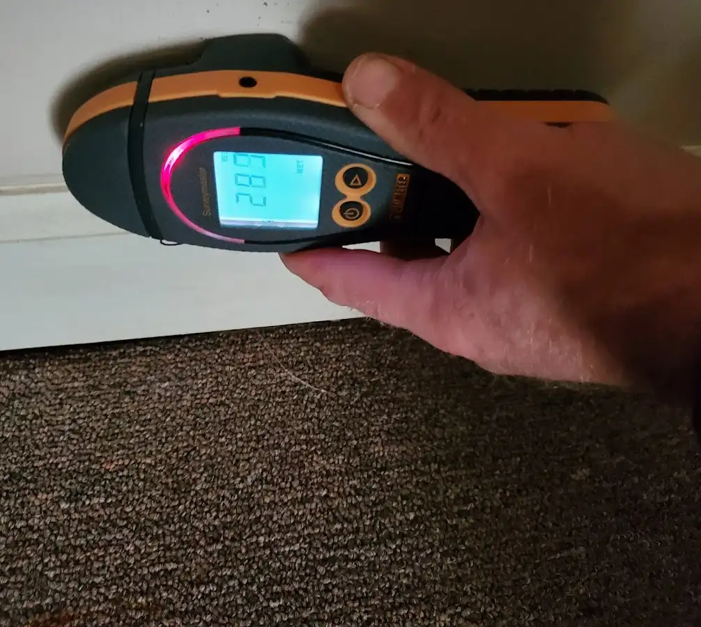 Moisture detection at baseboard during Storm Damage Restoration in West Little River